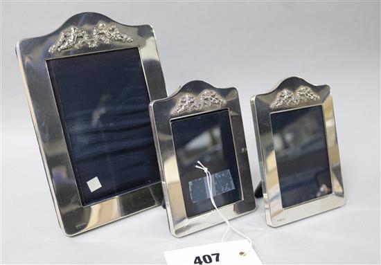 Three silver mounted photograph frames.